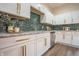 Close up shot of modern kitchen cabinets, backsplash and counter tops in a home with stainless appliances at 5511 E University Ave, Indianapolis, IN 46219