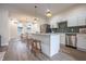 Bright, modern kitchen with white cabinets, stainless steel appliances and island with seating at 5511 E University Ave, Indianapolis, IN 46219