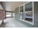 Covered porch with brick columns, offering a sheltered outdoor space with ample light at 5511 E University Ave, Indianapolis, IN 46219