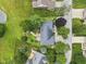 Aerial view features a well-maintained landscape, mature trees, backyard stone path, and nearby pond at 5591 Royal Troon Way, Avon, IN 46123