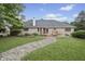 The rear exterior features a brick facade, deck, patio, and landscaped yard with a stone path at 5591 Royal Troon Way, Avon, IN 46123