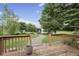 Deck overlooks a lush backyard, a stone pathway and a charming gazebo by the pond at 5591 Royal Troon Way, Avon, IN 46123