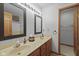 Bathroom featuring double sinks, updated mirrors, and access to a storage closet at 5591 Royal Troon Way, Avon, IN 46123
