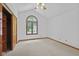 Bright bedroom featuring a vaulted ceiling, neutral carpet, and large arched window at 5591 Royal Troon Way, Avon, IN 46123