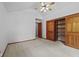 This bedroom offers a spacious layout, neutral carpet, ceiling fan, and convenient closet access at 5591 Royal Troon Way, Avon, IN 46123
