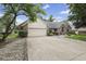 Spacious concrete driveway leading to a two car garage surrounded by mature trees and landscaping at 5591 Royal Troon Way, Avon, IN 46123