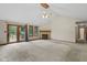 Bright living room featuring neutral carpet, fireplace, and sliding door access to the patio at 5591 Royal Troon Way, Avon, IN 46123