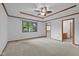 Main bedroom featuring trim details, ceiling fan, large window, and closet access at 5591 Royal Troon Way, Avon, IN 46123