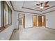 Main bedroom with trim details, ceiling fan, large window, closet and bathroom access at 5591 Royal Troon Way, Avon, IN 46123
