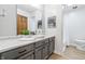 Bathroom features a modern vanity, marble countertop, and gray cabinets at 5982 Oak Hill East Dr, Plainfield, IN 46168