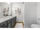 Stylish bathroom featuring modern vanity with marble countertop and gray cabinets at 5982 Oak Hill East Dr, Plainfield, IN 46168
