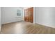 Bright bedroom with light wood flooring and a window for natural light at 5982 Oak Hill East Dr, Plainfield, IN 46168