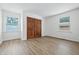 A bright bedroom, featuring modern flooring and closet doors at 5982 Oak Hill East Dr, Plainfield, IN 46168