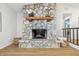 A stone fireplace with a wooden mantel and decorative items accents the living area at 5982 Oak Hill East Dr, Plainfield, IN 46168