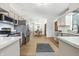 Bright kitchen with stainless steel appliances, white cabinets, and views to dining area at 5982 Oak Hill East Dr, Plainfield, IN 46168