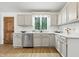 Bright kitchen featuring white cabinets, stainless steel appliances, and light wood flooring at 5982 Oak Hill East Dr, Plainfield, IN 46168
