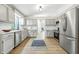 Open kitchen with white cabinets, stainless steel appliances, and view to dining area at 5982 Oak Hill East Dr, Plainfield, IN 46168