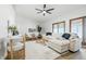Bright living room featuring a sectional sofa, wood floors, a ceiling fan, and natural light from the sliding doors at 5982 Oak Hill East Dr, Plainfield, IN 46168