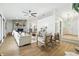Bright living room with stone fireplace, ceiling fan, neutral furniture, and light wood floors at 5982 Oak Hill East Dr, Plainfield, IN 46168