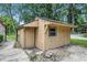Exterior view of a shed structure with an attached covered area that could be used as a carport at 5982 Oak Hill East Dr, Plainfield, IN 46168