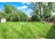 The expansive backyard features a storage shed and mature trees at 621 S Jefferson St, Brownsburg, IN 46112