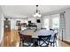 Bright dining room features a round table and an open view to kitchen at 621 S Jefferson St, Brownsburg, IN 46112