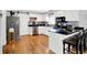 Well-appointed kitchen featuring white cabinetry, stainless steel appliances, and sleek black countertops with a breakfast bar at 621 S Jefferson St, Brownsburg, IN 46112