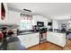 Bright kitchen featuring white cabinetry, stainless steel appliances, and sleek black countertops with bar seating at 621 S Jefferson St, Brownsburg, IN 46112