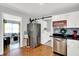 Spacious kitchen showcasing white cabinetry, stainless steel appliances, and access to living room at 621 S Jefferson St, Brownsburg, IN 46112