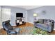Modern living room with neutral-toned walls, wood floors, and cozy seating arrangements and media center at 621 S Jefferson St, Brownsburg, IN 46112