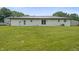 Expansive backyard view showcasing a well-maintained lawn and the rear of the property's white brick facade at 6609 Cordova Ct, Indianapolis, IN 46221