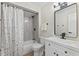 Bathroom with a shower and tub combination with white vanity and black hardware at 6609 Cordova Ct, Indianapolis, IN 46221