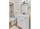 Bathroom features a shower and tub, toilet, a white vanity and a large mirror at 6609 Cordova Ct, Indianapolis, IN 46221