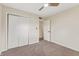 This bedroom is bright and modern, featuring a fan, closet and neutral carpet at 6609 Cordova Ct, Indianapolis, IN 46221