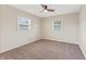 Carpeted bedroom features two windows and a ceiling fan at 6609 Cordova Ct, Indianapolis, IN 46221