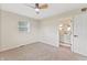 Carpeted bedroom with a window, door and ceiling fan at 6609 Cordova Ct, Indianapolis, IN 46221