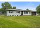 Exterior view of charming home with well-maintained lawn, mature trees, and updated roof at 6609 Cordova Ct, Indianapolis, IN 46221