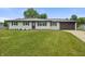 Charming exterior view of home with a manicured front lawn and a two-car garage at 6609 Cordova Ct, Indianapolis, IN 46221
