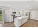 Bright kitchen features white cabinets, stainless steel appliances, and a large center island at 6609 Cordova Ct, Indianapolis, IN 46221