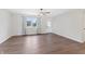 Spacious living room with updated flooring, bright natural light, and a ceiling fan at 6609 Cordova Ct, Indianapolis, IN 46221