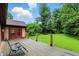 Back deck featuring chair, wooden posts, and backyard access with red framed doors at 6655 Teeters Ln, Martinsville, IN 46151