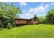 Lush backyard featuring mature trees and partial exterior view of home at 6655 Teeters Ln, Martinsville, IN 46151