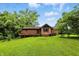 Spacious backyard with a well-maintained lawn, deck, and mature trees at 6655 Teeters Ln, Martinsville, IN 46151