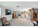 Large finished basement with TV, seating, stairs, and view into laundry area at 6655 Teeters Ln, Martinsville, IN 46151