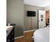 A relaxing bedroom setting with wall mounted TV, hardwood floors, and a door to the landing at the top of the stairs at 6655 Teeters Ln, Martinsville, IN 46151