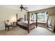 A bright bedroom features a four-poster bed, a bay window with a cushioned seat and plush pillows at 6655 Teeters Ln, Martinsville, IN 46151