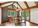 Bright dining area features exposed beam ceiling, hardwood floors, and natural light through large windows at 6655 Teeters Ln, Martinsville, IN 46151