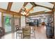 Bright dining area features exposed beam ceiling, hardwood floors, and views into the kitchen at 6655 Teeters Ln, Martinsville, IN 46151