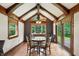 Bright dining area features exposed beam ceiling, hardwood floors, and natural light through large windows at 6655 Teeters Ln, Martinsville, IN 46151