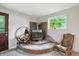 Cozy corner fireplace with wood storage and rocking chair, perfect for relaxation at 6655 Teeters Ln, Martinsville, IN 46151